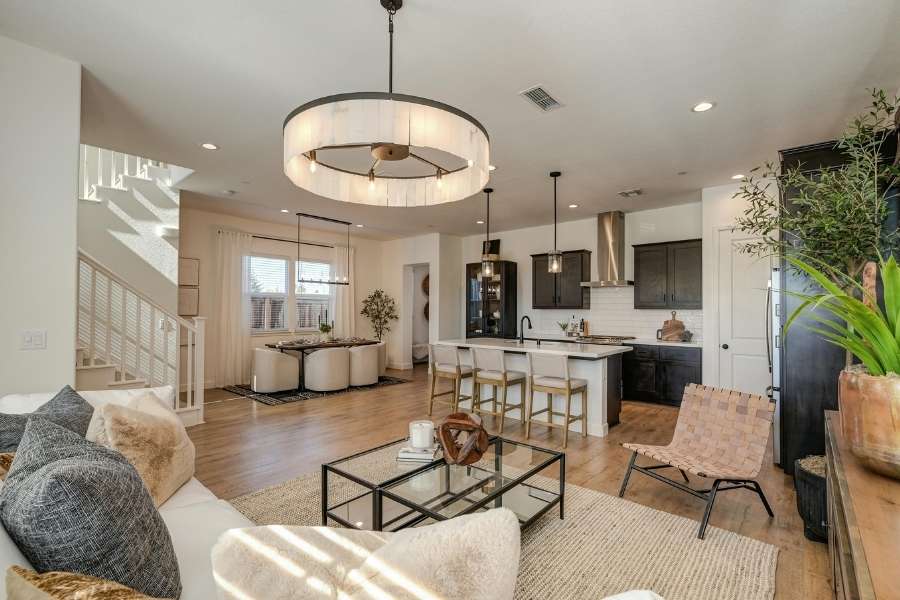 Modern living room featuring a striking statement lighting chandelier hanging over the open space.